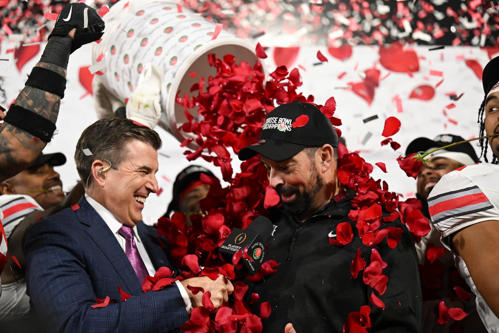 Ohio State players dunk rose petals on head coach Ryan Day after winning the quarterfinals of the Rose Bowl College Football Playoff against Oregon, Wednesday, Jan. 1, 2025, in Pasadena, Calif. (AP Photo/Kyusung Gong)