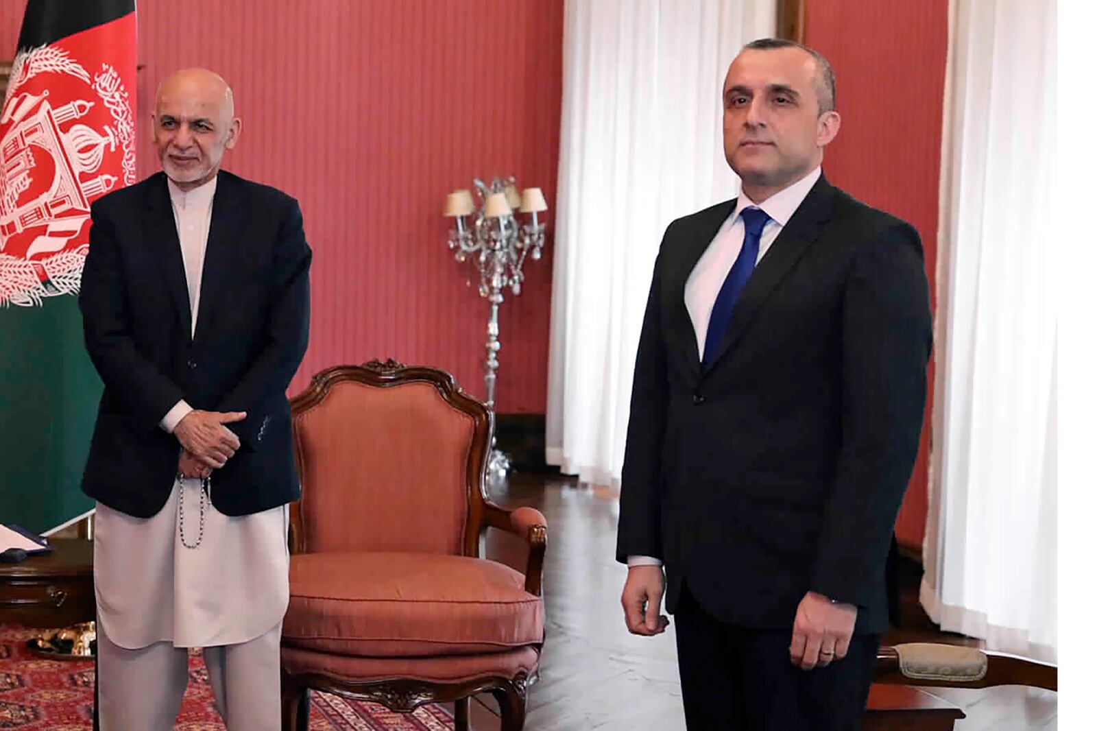 FILE - In this March 23, 2020, file photo, First Vice President Amrullah Saleh, right, and Afghan President Ashraf Ghani,left, attend a meeting with 
U.S. Secretary of State Mike Pompeo, at the Presidential Palace in Kabul. Afghan officials claimed a failed assassination attempt against Afghanistan's first vice president Saleh. Razwan Murad, a spokesman for the first vice president said Wednesday, Sept. 9, that the enemies of Afghanistan again tried to harm Saleh, but the vicious and terrorist attempt has failed and Saleh has survived. (Afghan Presidential Palace via AP, File)