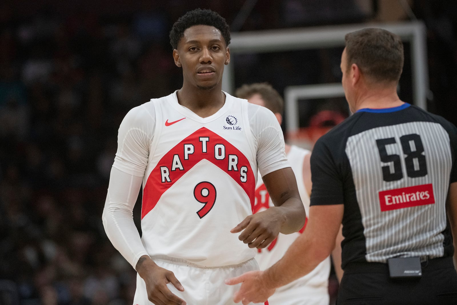 Toronto Raptors' RJ Barrett (9) talks with referee Josh Tiven (58) after being called for a technical foul against the Cleveland Cavaliers during the first half of an NBA basketball game in Cleveland, Thursday, Jan. 9, 2025. (AP Photo/Phil Long)