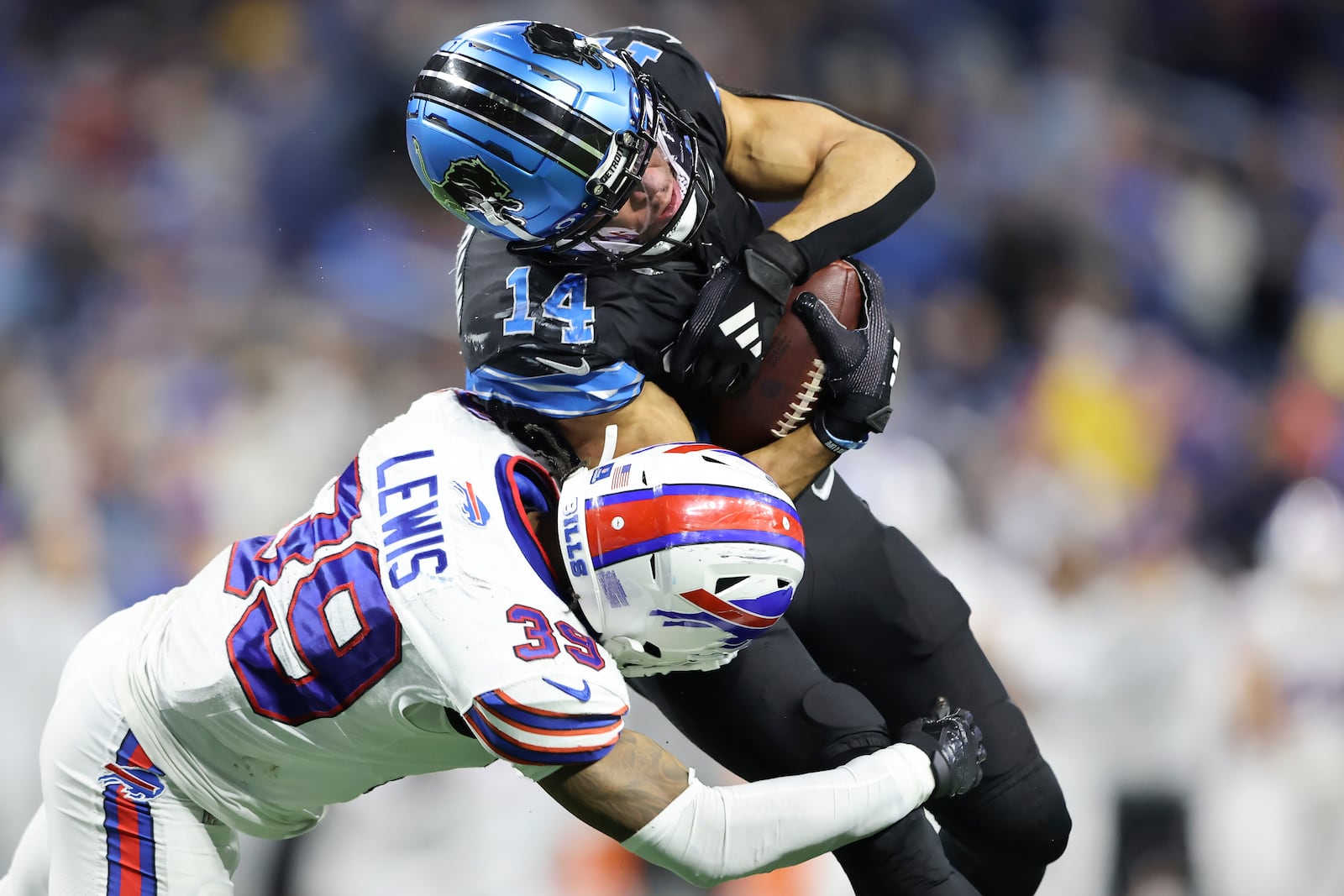 Detroit Lions wide receiver Amon-Ra St. Brown (14) is tackled by Buffalo Bills cornerback Cam Lewis (39) during the second half of an NFL football game, Sunday, Dec. 15, 2024, in Detroit. (AP Photo/Rey Del Rio)