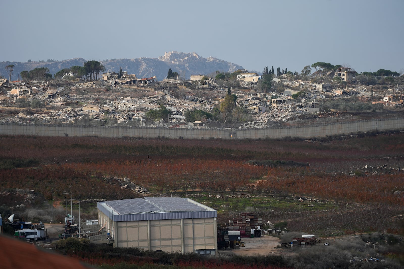 Parts of the southern Lebanese town of Kfar Kila are seen flattened by bombardments from Metula, Israel's northernmost town, on Wednesday, December 4, 2024. (AP Photo/Ohad Zwigenberg)