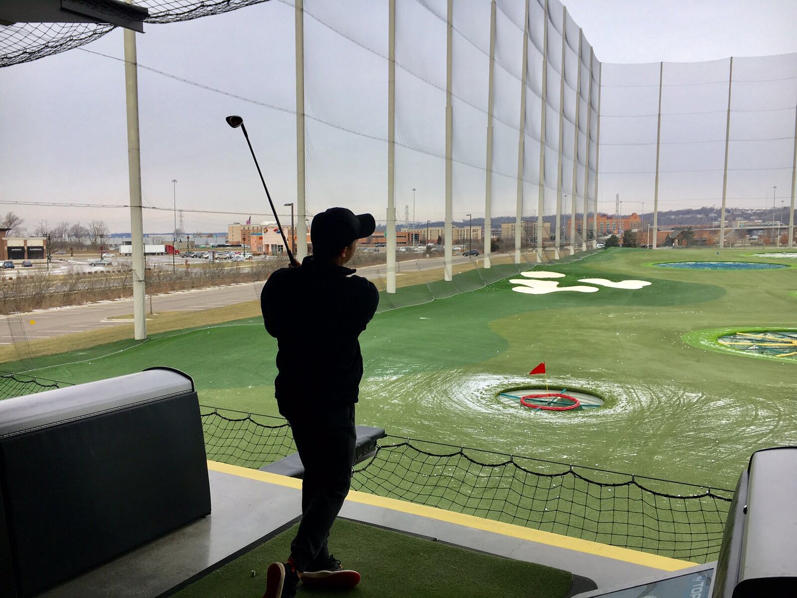 Bitter winter cold doesn’t slow the swing of one of the hundreds of happy duffers who made their way to West Chester Township’s Top Golf attraction. The three-story driving range includes state-of-the-art heaters that keeps golfers 20-degrees warmer than outside temperature.