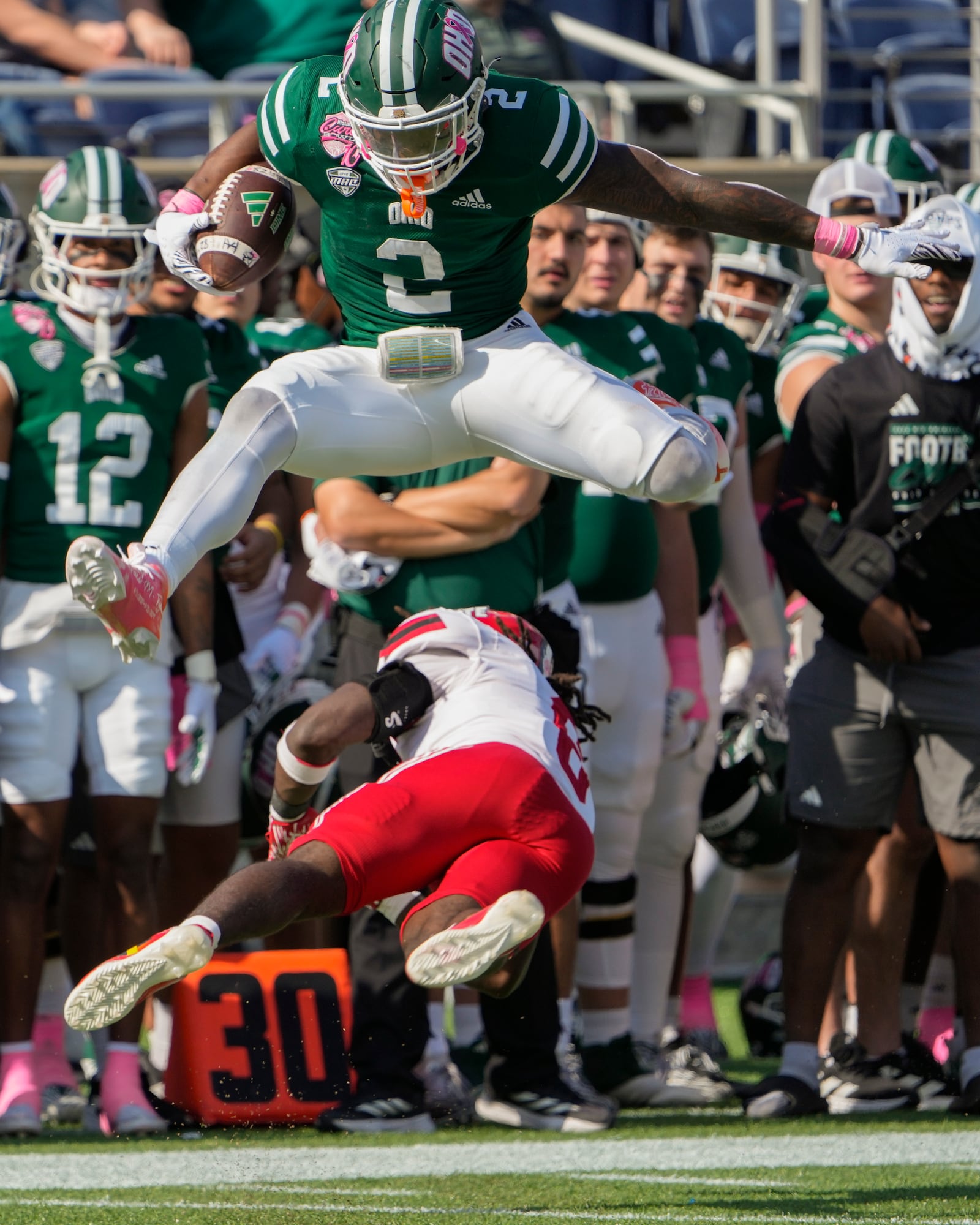 Ohio running back Anthony Tyus III (2) leaps over Jacksonville State safety Antonio Carter for extra yardage on a run during the first half of the Cure Bowl NCAA college football game, Friday, Dec. 20, 2024, in Orlando, Fla. (AP Photo/John Raoux)