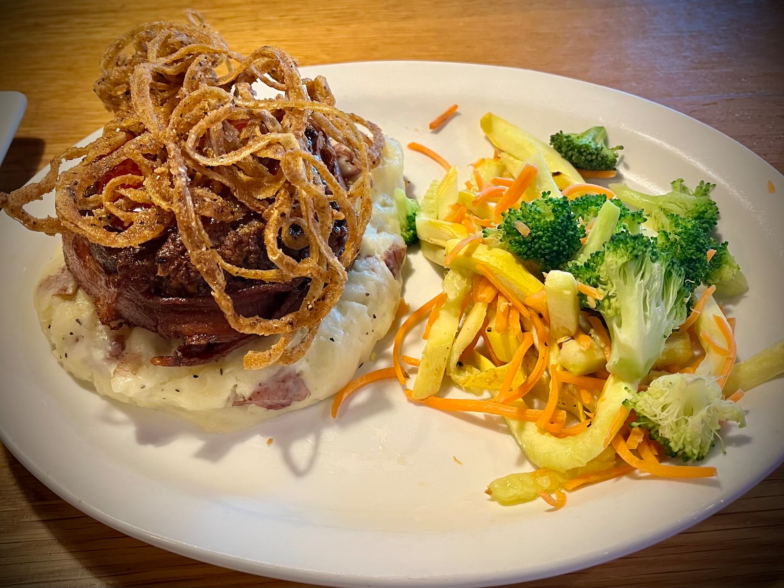 Pictured is the home-style meatloaf with bacon, cheddar and a sweet, smoky glazed. It was topped with fried onions and served with mashed potatoes and veggies. NATALIE JONES/STAFF