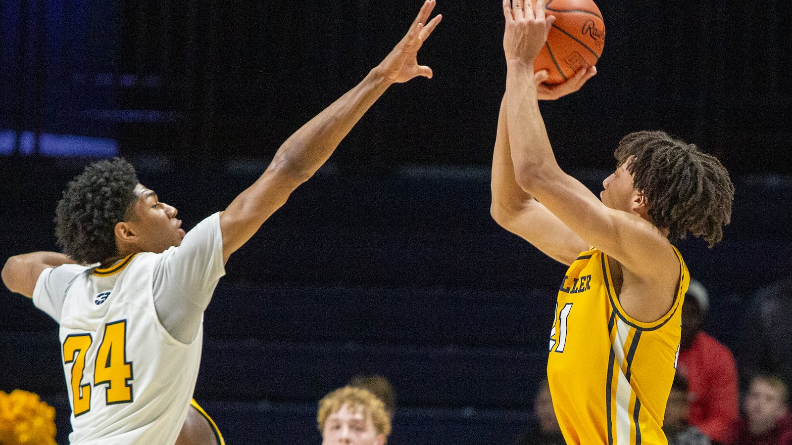 Centerville's Boubacarr Njie challenges a shot by Cincinnati Moeller's Alex Kazanecki, who scored 34 points, at the Cintas Center Saturday. Centerville won the Division I region title 70-69 in double overtime. Jeff Gilbert/CONTRIBUTED