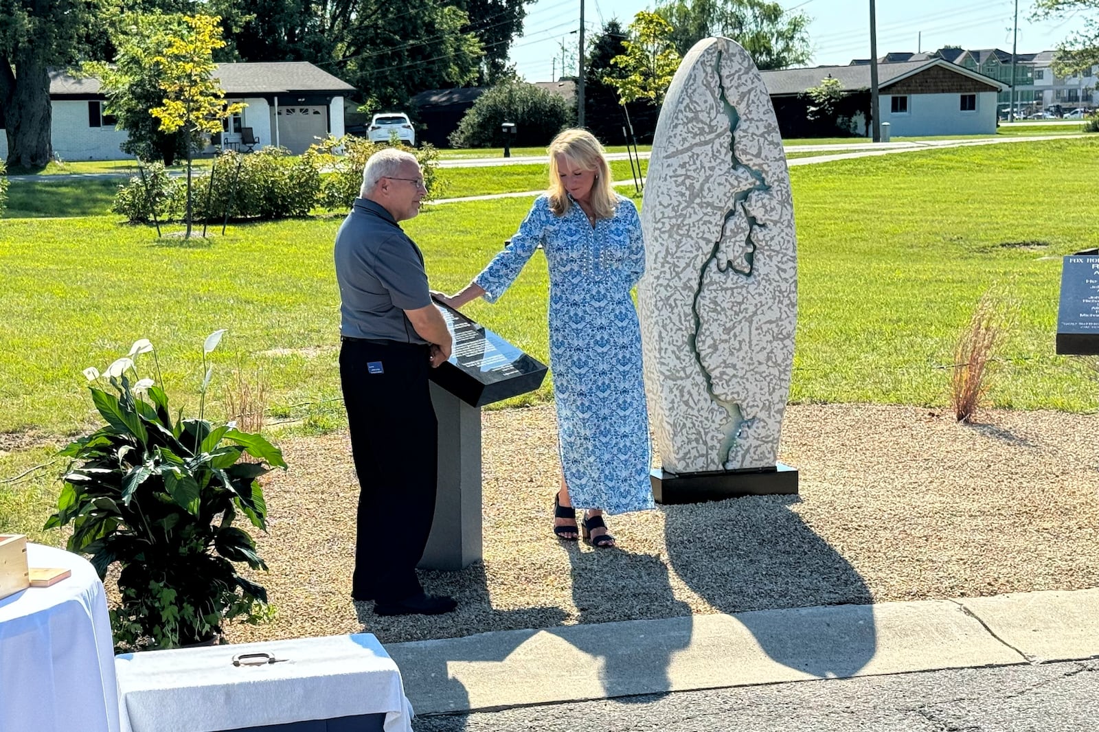 Hamilton County Coroner Jeff Jellison and Linda Znachko, founder of the nonprofit Indianapolis-based ministry He Knows Your Name, look at a marker on August 29, 2024, in Westfield, Indiana, that lists the names of the nine known victims of suspected serial killer Herbert Baumeister. (AP Photo/Rick Callahan)