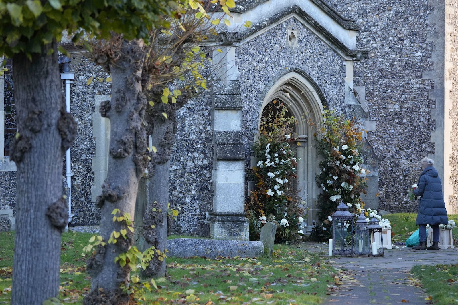 A florist arranges flowers ahead of the funeral service for One Direction singer Liam Payne at a church in the Home Counties, England, Wednesday Nov. 20, 2024. (Andrew Matthews/PA via AP)