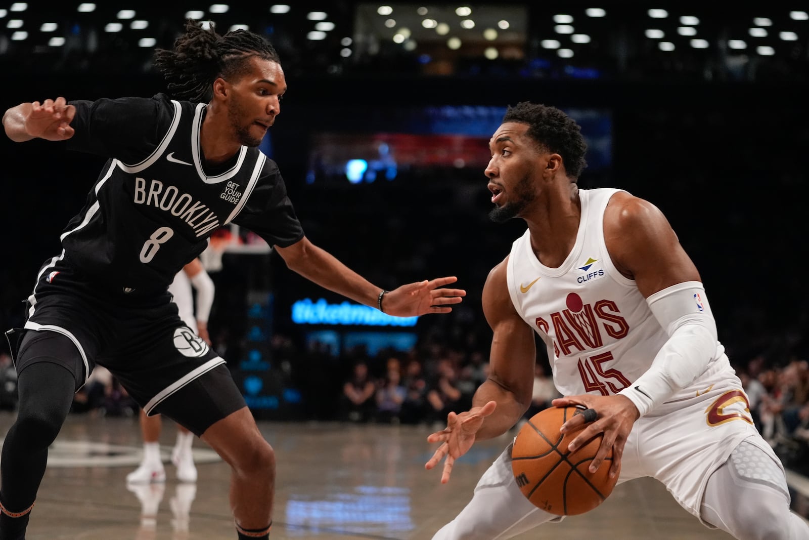 Brooklyn Nets' Ziaire Williams (8) defends Cleveland Cavaliers' Donovan Mitchell (45) during the first half of an NBA basketball game Thursday, Feb. 20, 2025, in New York. (AP Photo/Frank Franklin II)