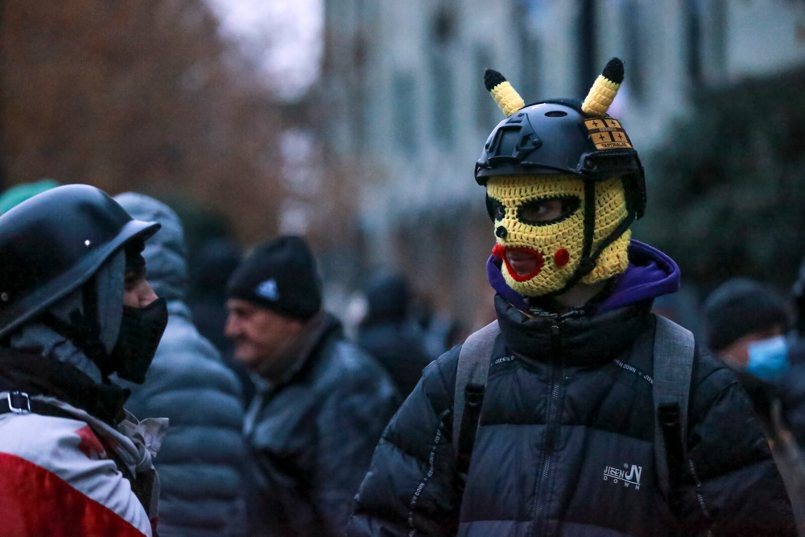 Protesters gather in a street during a rally to demand new parliamentary elections in the country, near the Parliament's building in Tbilisi, Georgia, on Monday, Nov. 25, 2024. (AP Photo/Zurab Tsertsvadze)