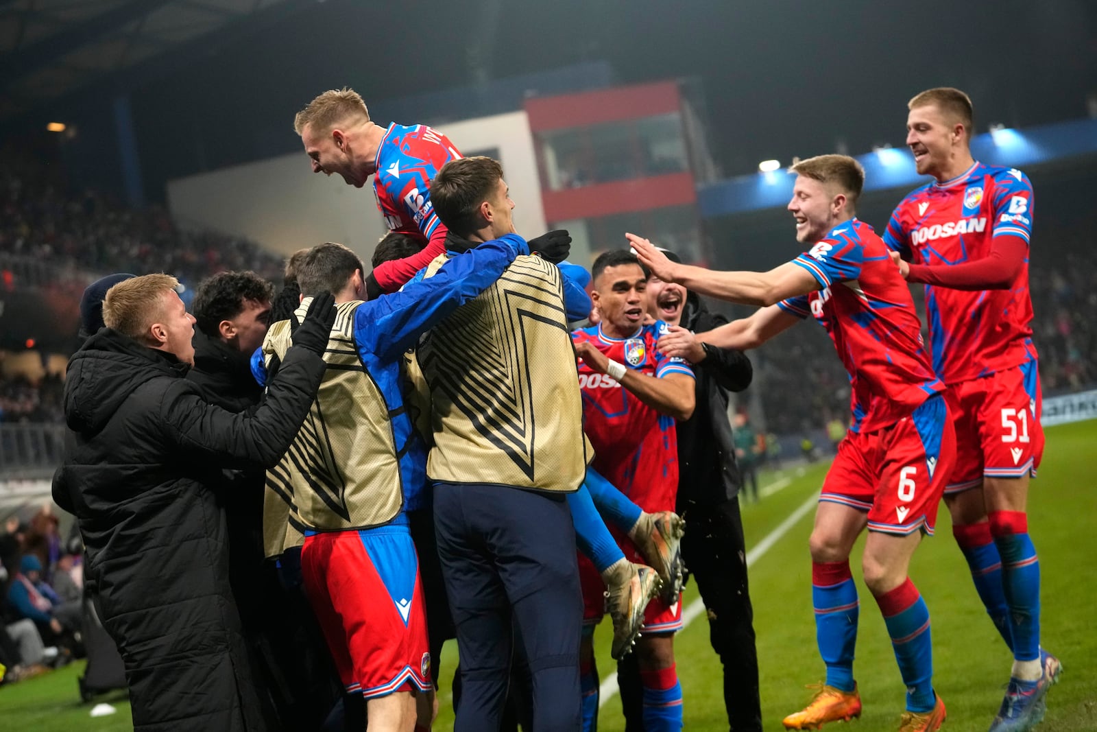 Plzen's Matej Vydra, top left, celebrates after scoring his side's opening goal during the Europa League soccer match between Viktoria Plzen and Manchester United at the Doosan Arena in Plzen, Czech Republic, Thursday, Dec. 12, 2024. (AP Photo/Petr David Josek)