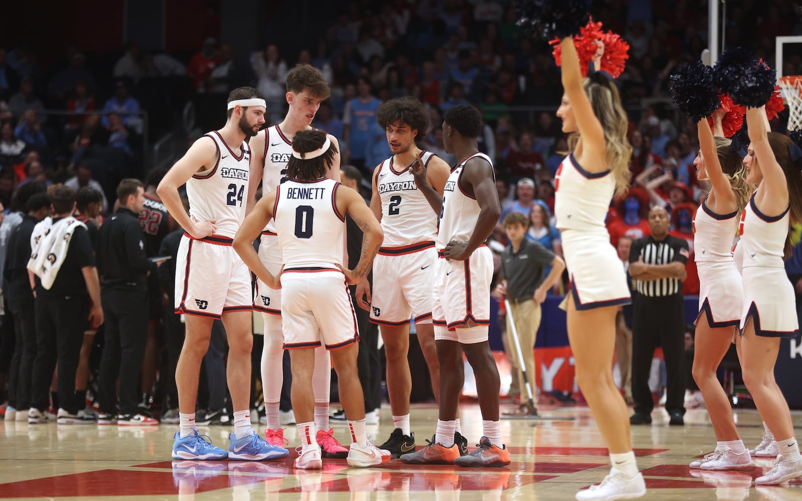 Dayton players huddle during a game against Saint Joseph’s on Friday, Jan. 24, 2025, at UD Arena. David Jablonski/Staff