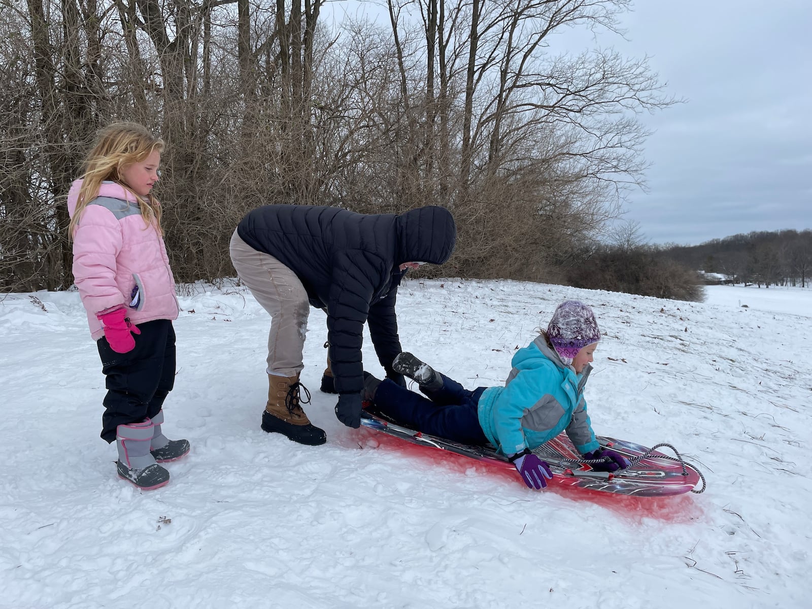 Mindy Skiles helps her daughter, Bethany, sled down Hawkins Hill on Fairgrounds Road in Xenia on Tuesday, Jan. 7. NATALIE JONES/STAFF