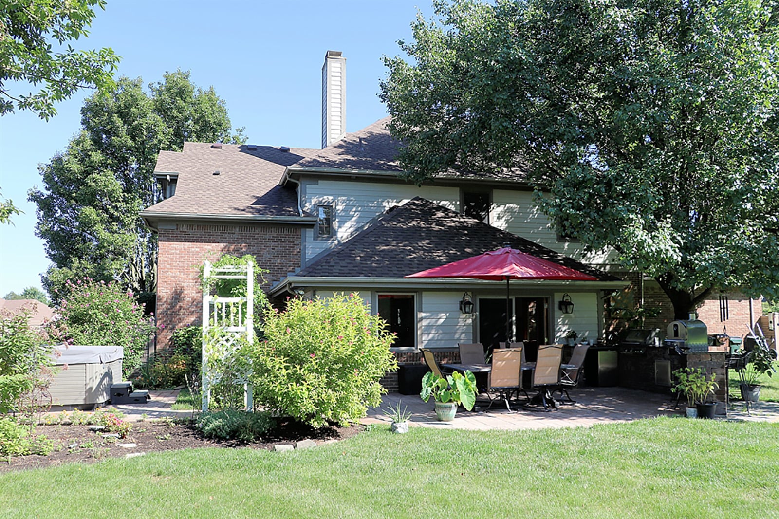 A 4-season room has a double tray ceiling, wainscoting and several windows for a panoramic view of the back yard. Oversized French doors open to the patio and outdoor kitchen. CONTRIBUTED PHOTO BY KATHY TYLER