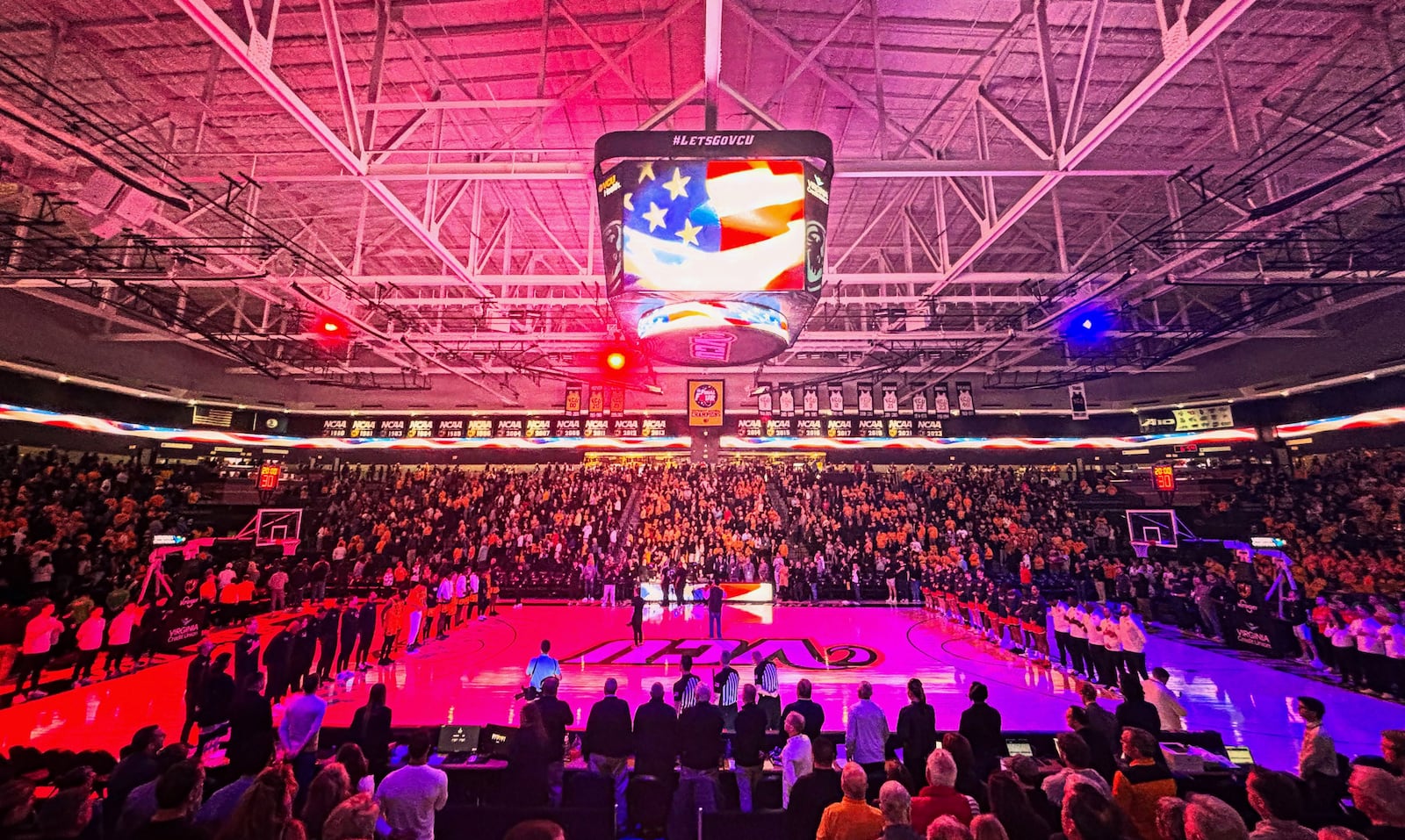 Dayton and Virginia Commonwealth stand for the national anthem before a game on Friday, March 7, 2025, at the Siegel Center in Richmond, Va. David Jablonski/Staff