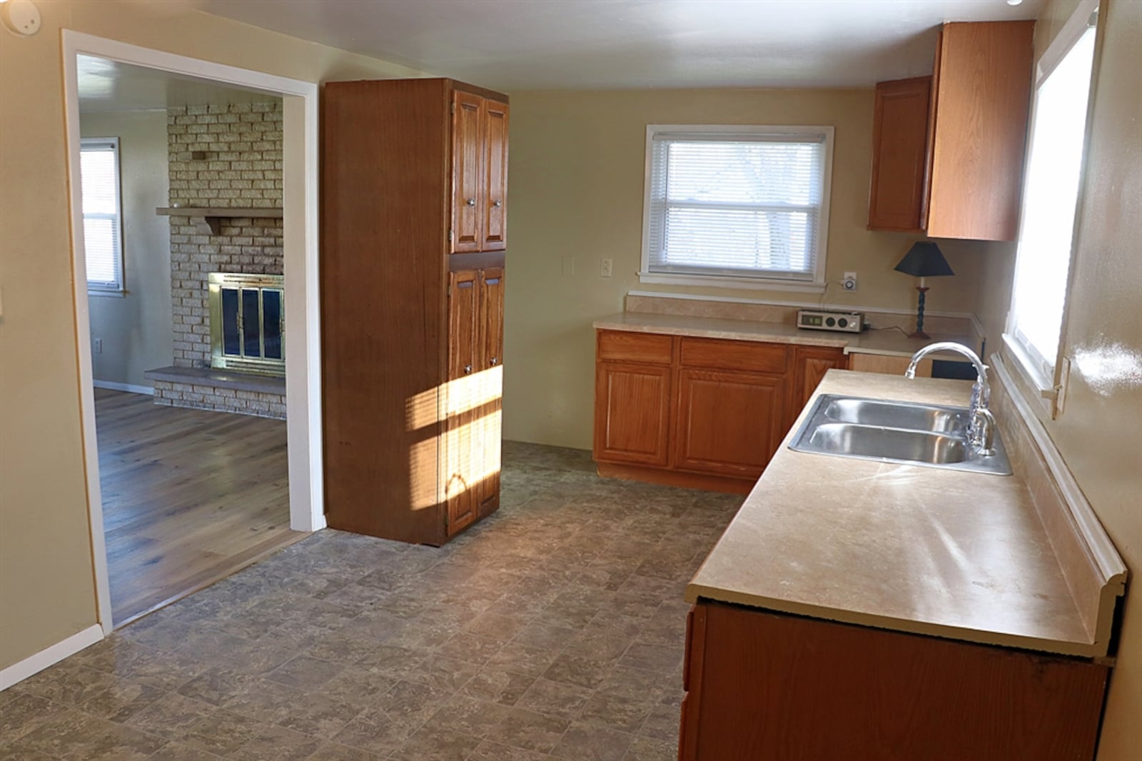 An open threshold leads into the eat-in kitchen. Two banks of cabinetry and counters offer plenty of preparation space. CONTRIBUTED BY KATHY TYLER