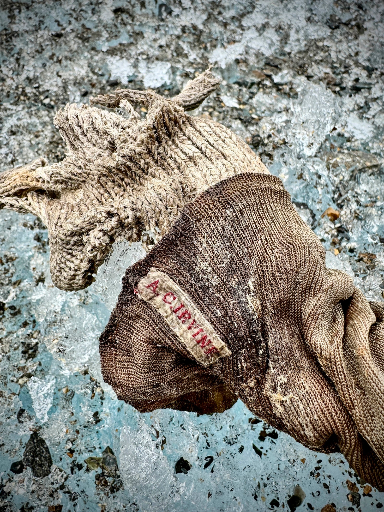 In this photo provided by National Geographic on Friday, Oct. 11, 2024, a sock embroidered with "A.C. Irvine", along with a boot, discovered on the Central Rongbuk Glacier below the North Face of Mount Everest by a team led by Jimmy Chin. (Jimmy Chin/National Geographic via AP)