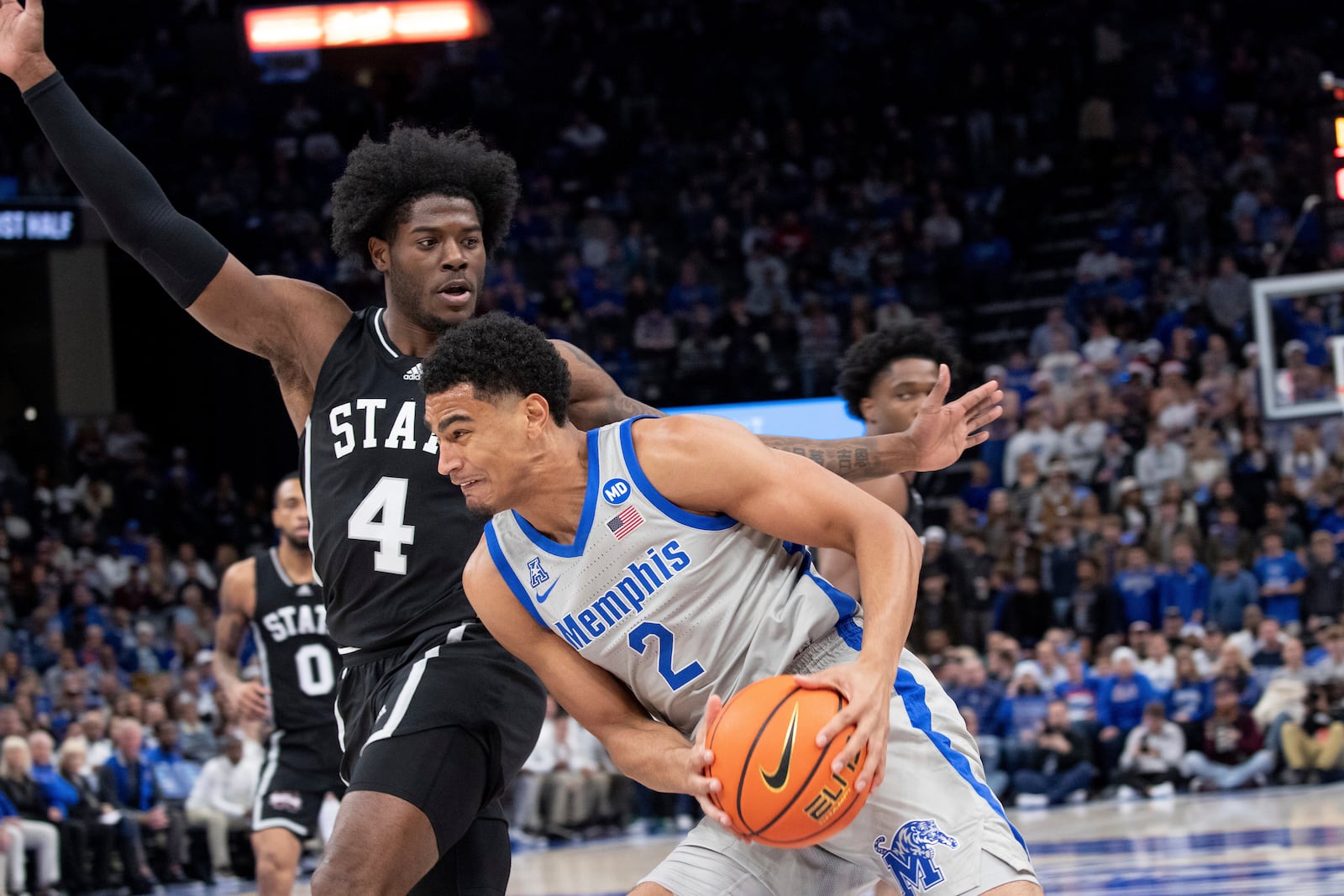 Mississippi State forward Cameron Matthews (4) defends Memphis forward Nicholas Jourdain (2) during the first half of an NCAA college basketball game Saturday, Dec. 21, 2024, in Memphis, Tenn. (AP Photo/Nikki Boertman)