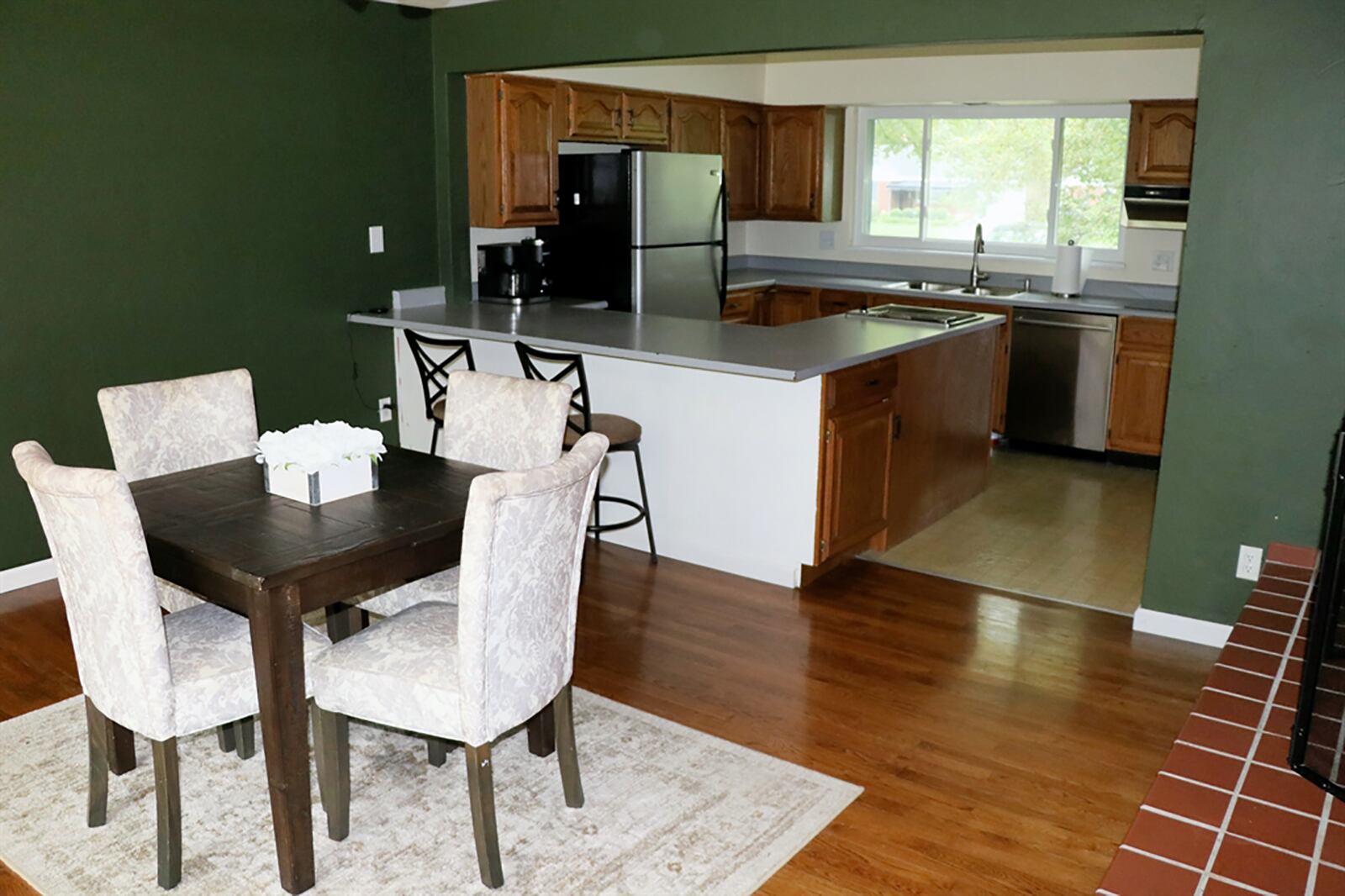 A peninsula countertop wraps around into the kitchen area, providing breakfast bar seating within the dining room for up to four and additional preparation space within the kitchen. The peninsula counter ends with a Jenn-Air grill. CONTRIBUTED PHOTO BY KATHY TYLER