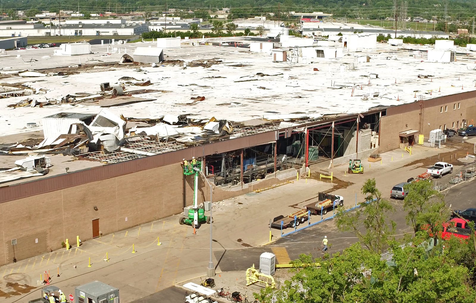 Aerial view looking northwest at the nearly 650,000 square foot Dayton Phoenix Group building on Kuntz Road in the Old North Dayton business park. The roof and walls were severely damaged  by a tornado on Memorial Day.Construction workers are beginning restoration work.  TY GREENLEES / STAFF