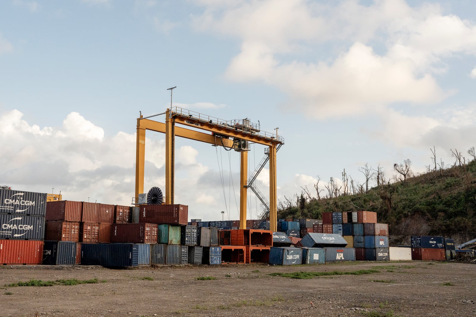 Fallen containers litter the Longoni port, Mayotte, Friday, Dec. 20, 2024. (AP Photo/Adrienne Surprenant)