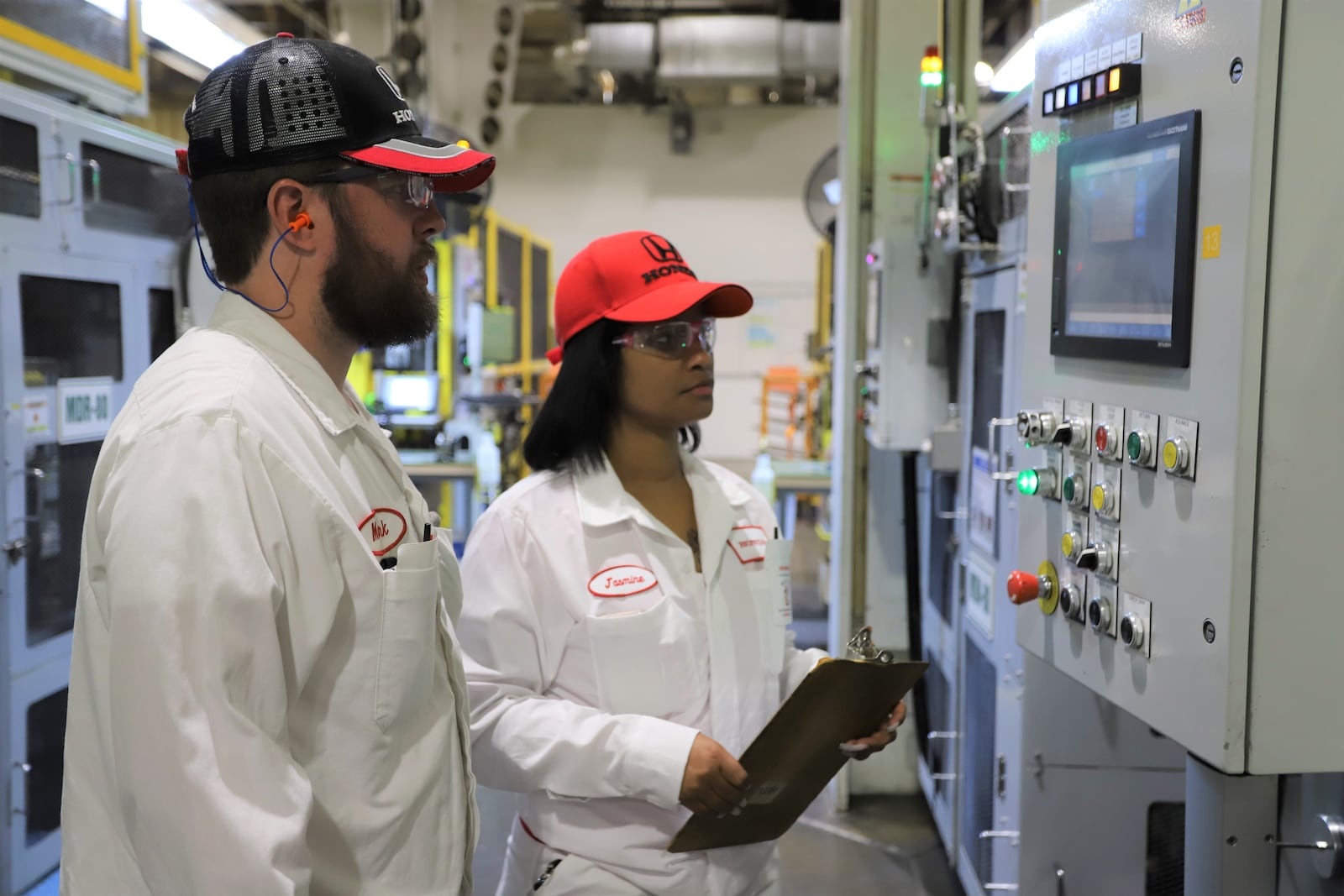 Honda employee Mark Mullen trains Jasmine Pitts on the pre-shift machine checks that ensure product quality at the Anna Engine Plant. Honda photo