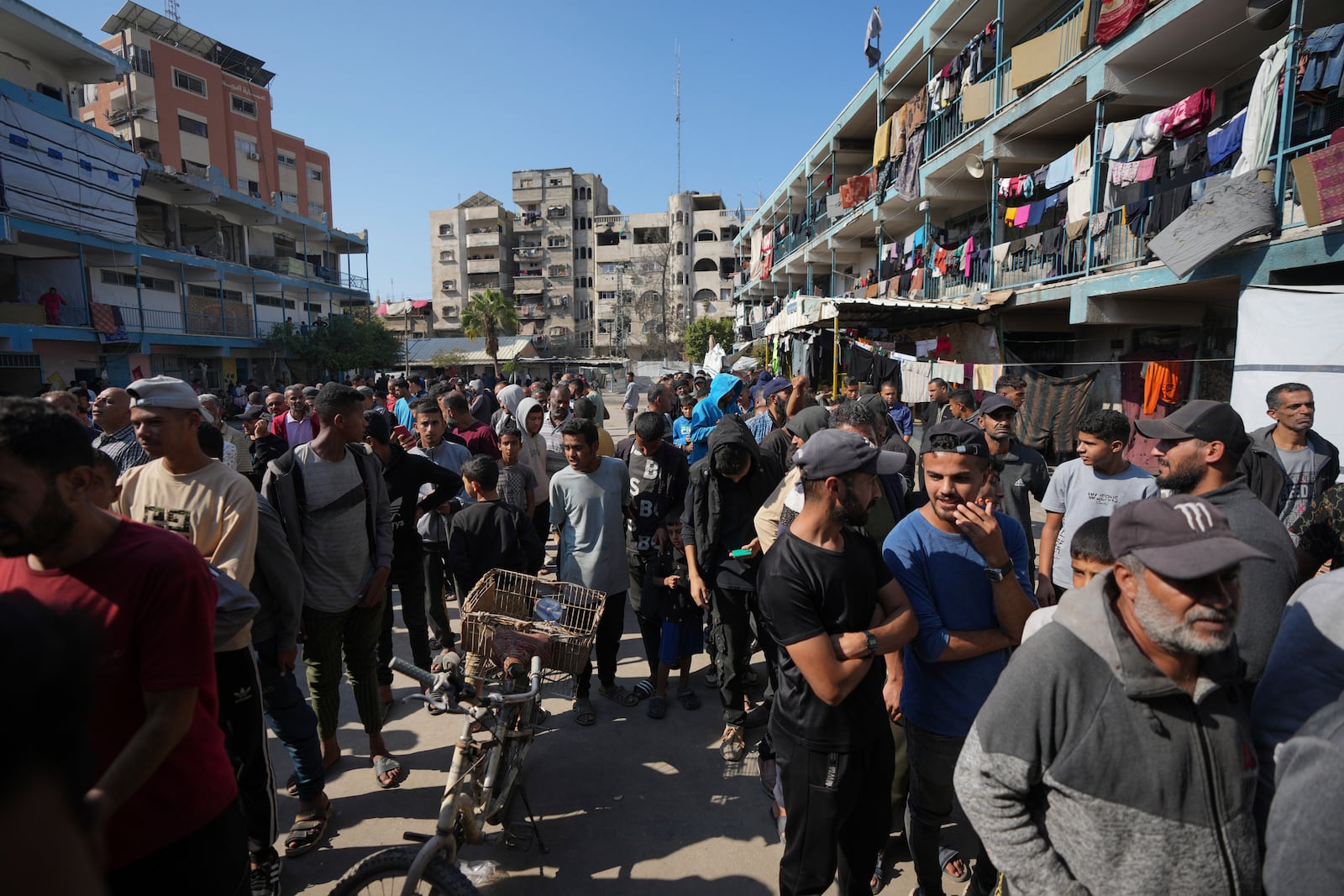 FILE - Palestinians gather to receive aid distributed by UNRWA, the U.N. agency helping Palestinian refugees, in Nusairat refugee camp, Gaza, on Nov. 5, 2024. (AP Photo/Abdel Kareem Hana, File)