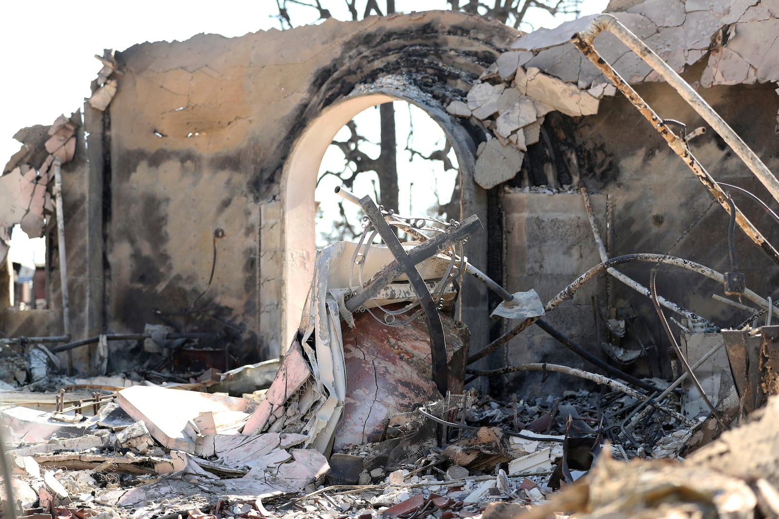 A bent cross amidst the rubble after the Altadena Community Church was destroyed by the Eaton Fire in Altadena, Calif., on Monday, Jan. 13, 2025. (Scott Strazzante/San Francisco Chronicle via AP)