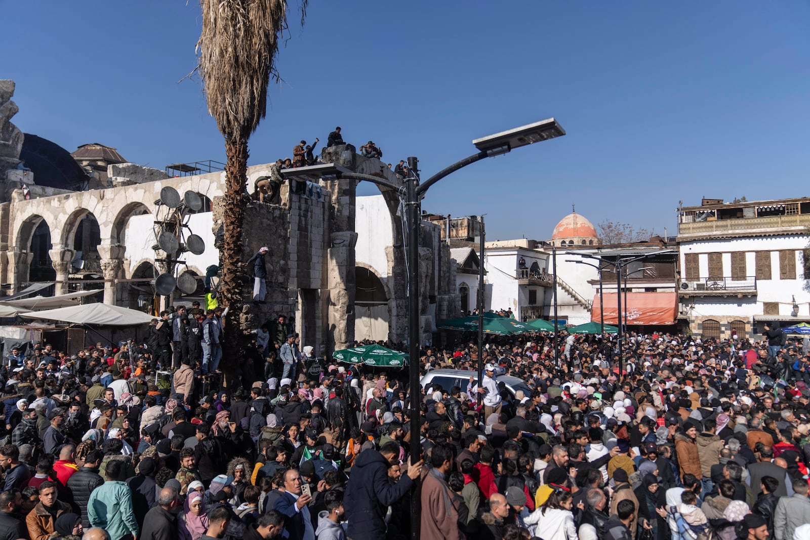 People gather to enter Umayyad Mosque for Friday prayers, in Damascus, Syria, Friday, Jan. 10, 2025. (AP Photo/Mosa'ab Elshamy)