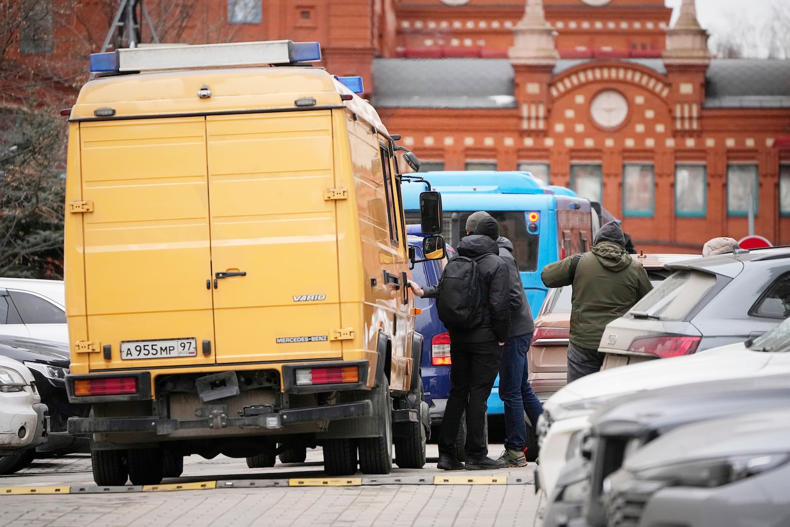 Bomb disposal experts stand in the yard of an upscale residential block in Moscow, Russia, Monday, Feb. 3, 2025, where the blast has killed one person and wounded four others, Russian news agencies say. (AP Photo/Alexander Zemlianichenko)