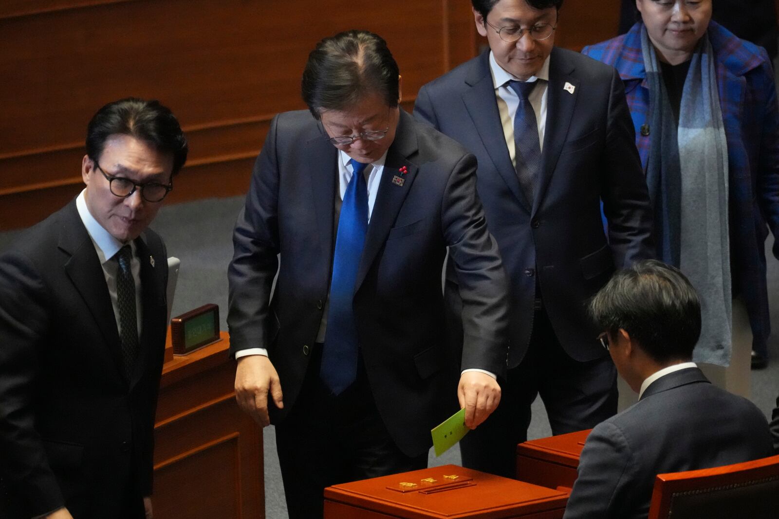 South Korea's main opposition Democratic Party leader Lee Jae-myung, center, casts a ballot on impeachment bills for the national Police Chief Cho Ji Ho and Justice Minister Park Sung Jae during a plenary session held relating to the martial law declaration, at the National Assembly in Seoul, South Korea, Thursday, Dec. 12, 2024. (AP Photo/Lee Jin-man)