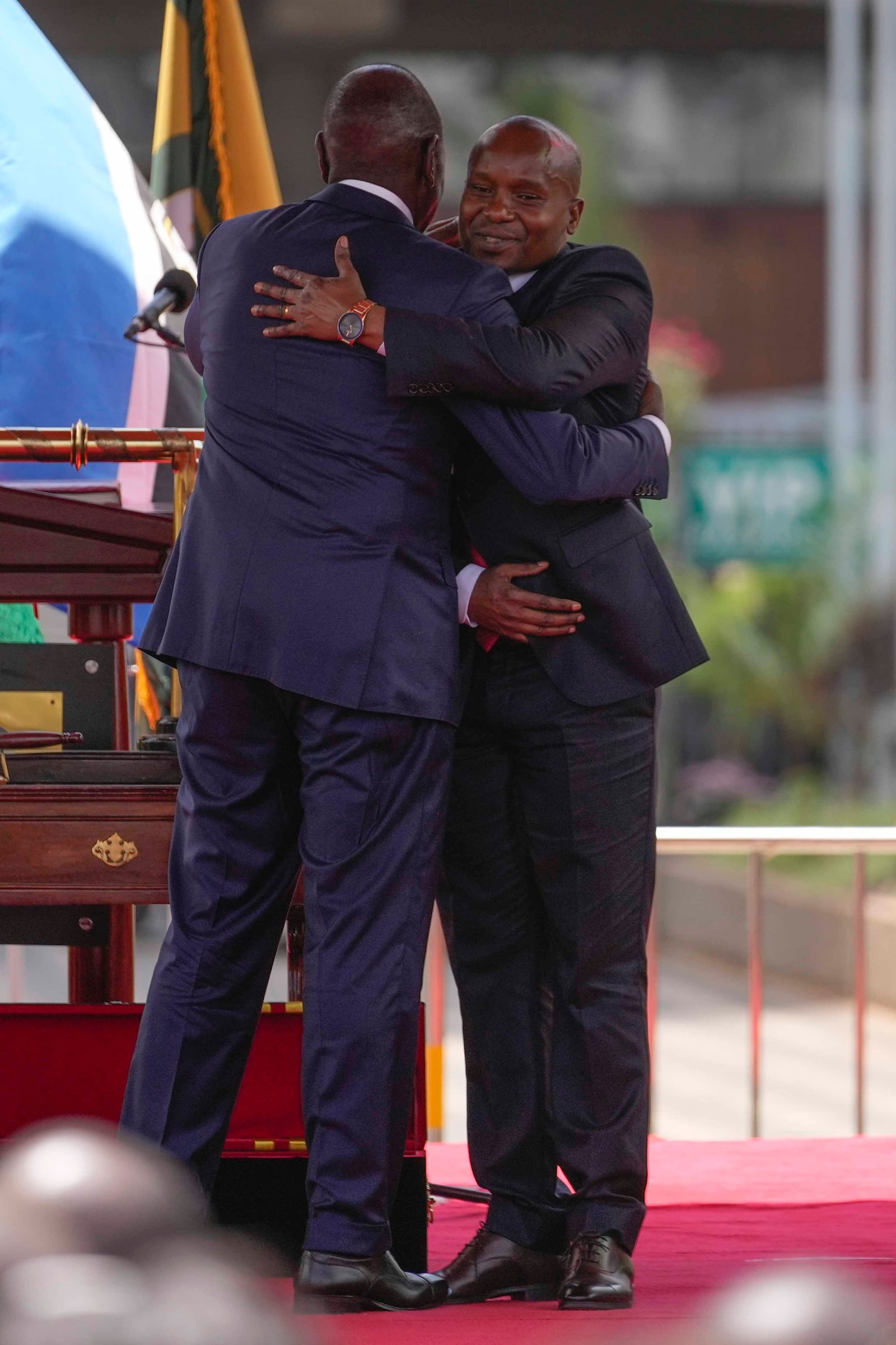 Kenya's new Deputy President Kithure Kindiki, right, hugs Kenya's President William Ruto, during his swearing in ceremony, at Kenyatta International Convention Centre, in Nairobi, Kenya Friday, Nov. 1, 2024. (AP Photo/Brian Inganga)