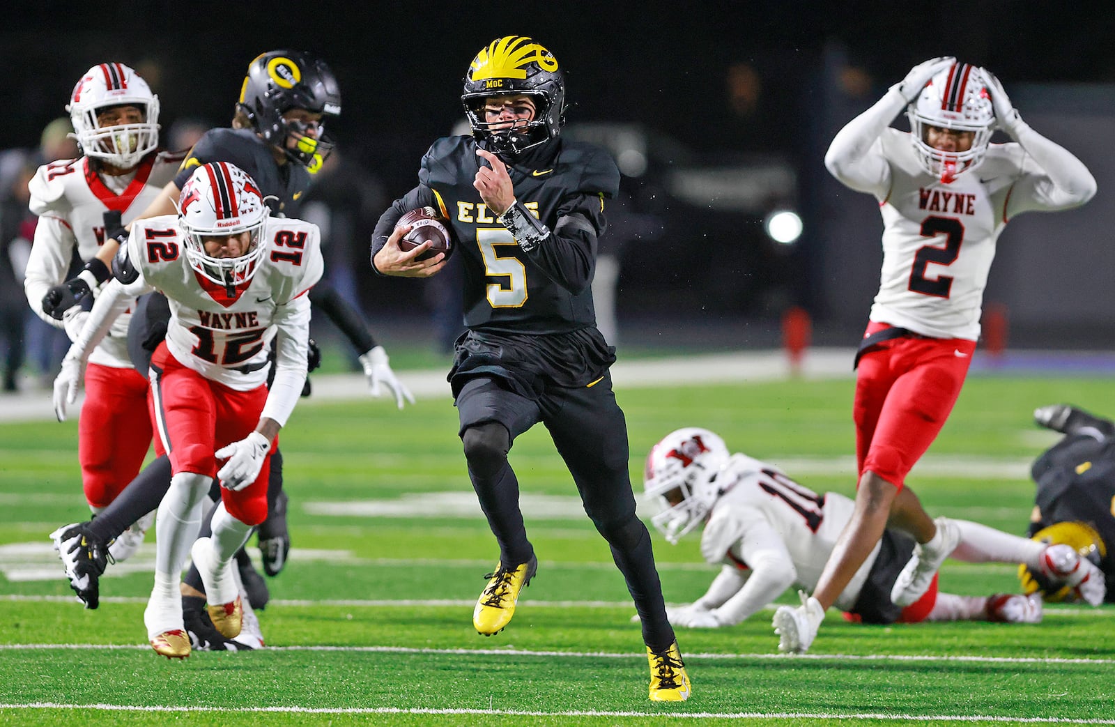 Centerville quarterback Shane Cole breaks into open field on a touchdown run that was called by due to holding during Friday's regional championship game. BILL LACKEY/STAFF