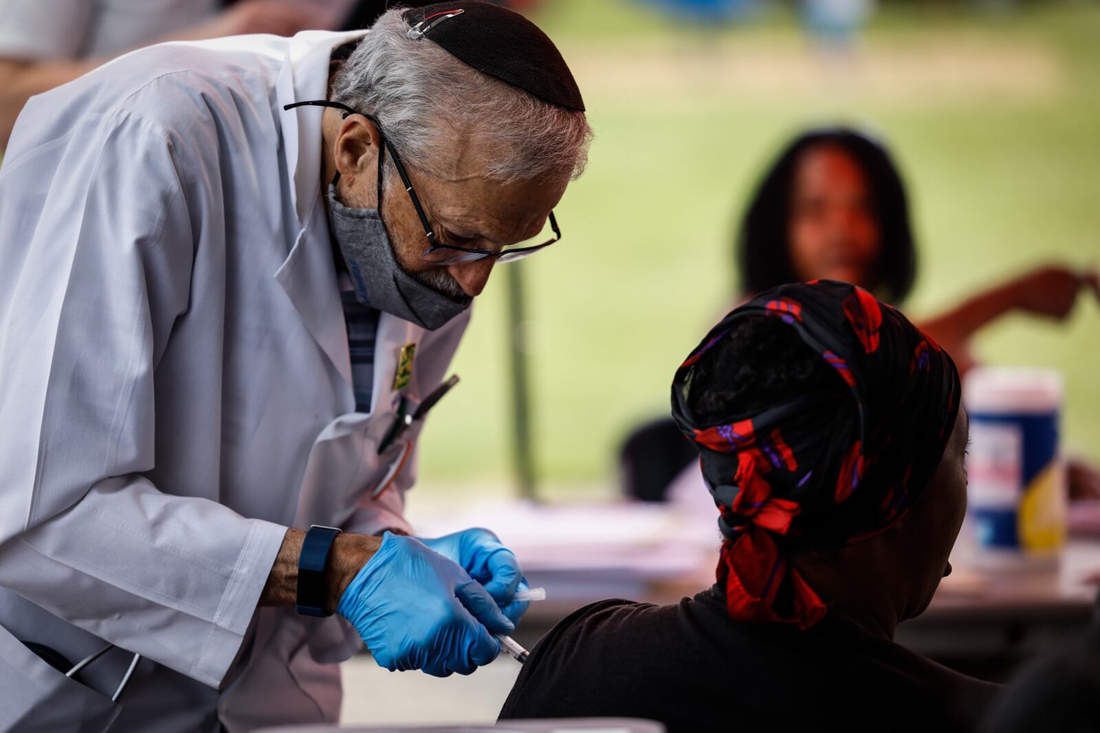 Zik''s Pharmacy volunteer Dr. David Novick administers a COVID-19 vaccine from the Zik's Pharmacy booth at a community fair held June 23, 2021. JIM NOELKER/STAFF