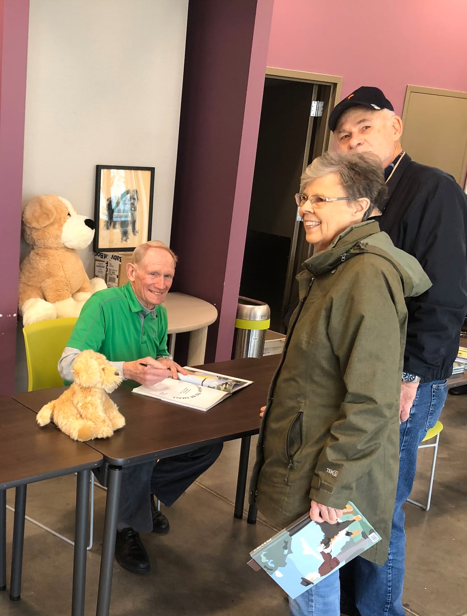 Dr. Doug Coatney (seated) at his first book signing in December of 2023. He is shown with Dave and Judy Hetzer.