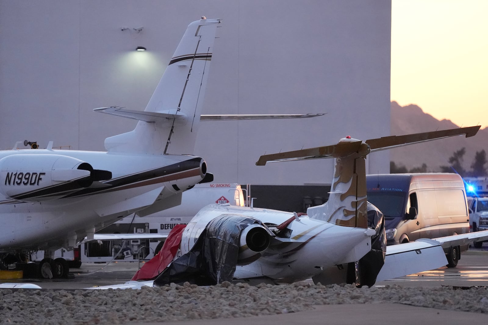 A crashed Learjet, right, sits damaged after colliding with another plane at Scottsdale Airport Monday, Feb. 10, 2025, in Scottsdale, Ariz. (AP Photo/Ross D. Franklin)