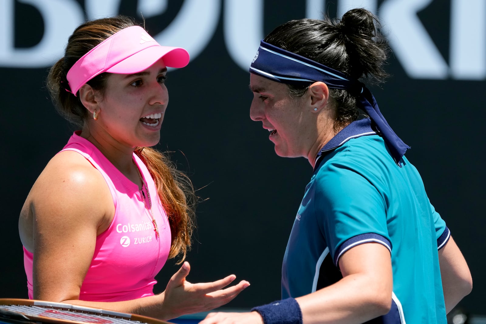 Ons Jabeur, right, of Tunisia is congratulated by Camila Osorio of Colombia following their second round match at the Australian Open tennis championship in Melbourne, Australia, Thursday, Jan. 16, 2025. (AP Photo/Manish Swarup)