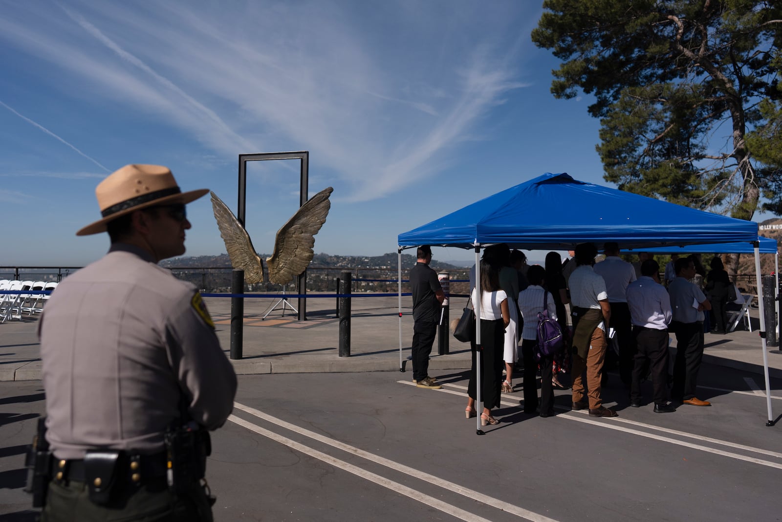 People gather under a tent as they check in to attend a naturalization ceremony at Griffith Observatory in Los Angeles, Monday, Oct. 21, 2024. (AP Photo/Jae C. Hong)