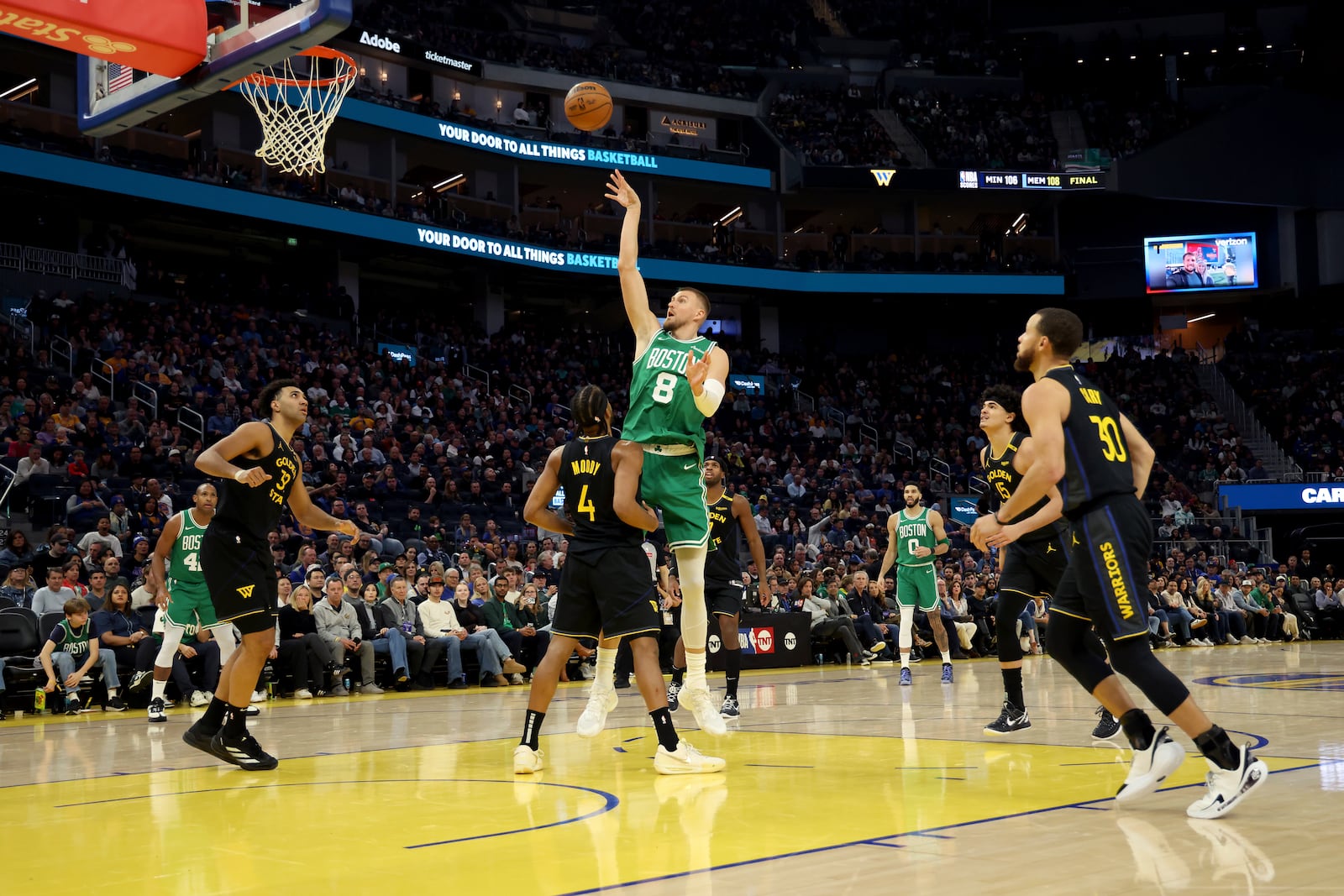 Boston Celtics center Kristaps Porzingis (8) shoots against Golden State Warriors guard Moses Moody (4) during the first half of an NBA basketball game in San Francisco, Monday, Jan. 20, 2025. (AP Photo/Jed Jacobsohn)