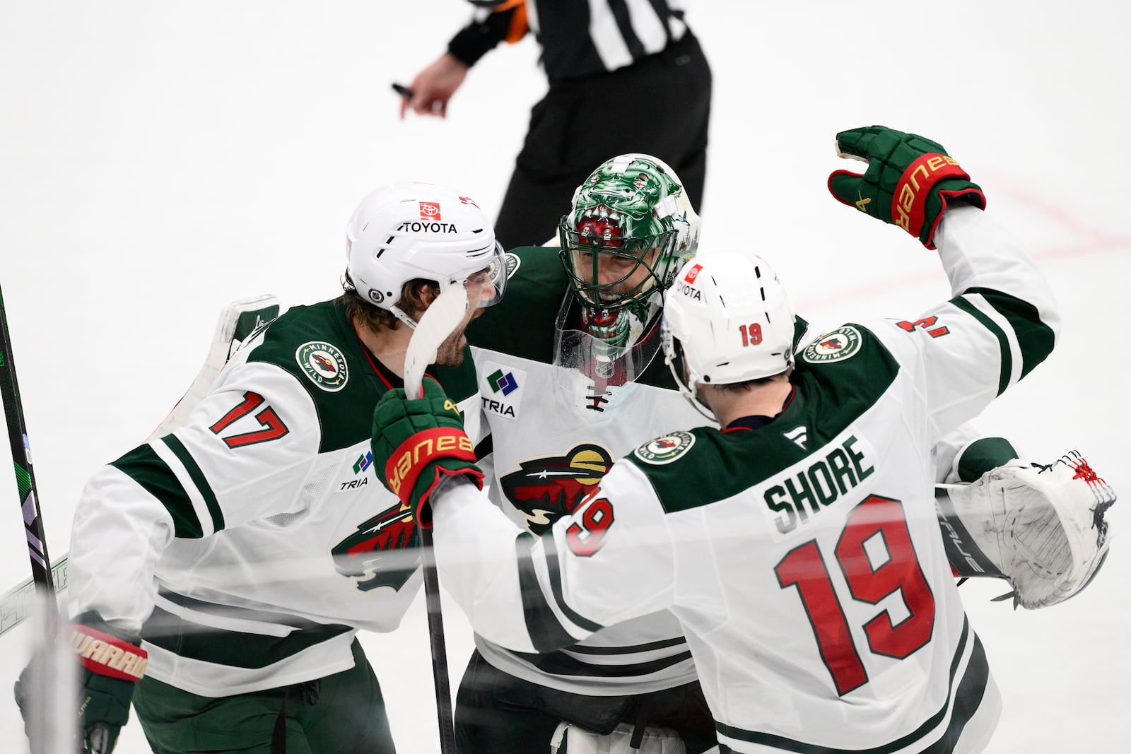 Minnesota Wild goaltender Marc-Andre Fleury, center, celebrates with left wing Marcus Foligno (17) and center Devin Shore (19) after an NHL hockey game against the Washington Capitals, Thursday, Jan. 2, 2025, in Washington. The Wild won 4-3 in a shootout. (AP Photo/Nick Wass)