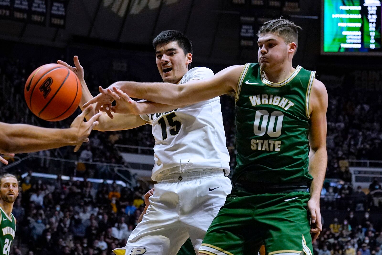 Purdue center Zach Edey (15) and Wright State forward Grant Basile (0) go for a rebound during the second half of an NCAA college basketball game in West Lafayette, Ind., Tuesday, Nov. 16, 2021. Purdue won 96-52. (AP Photo/Michael Conroy)