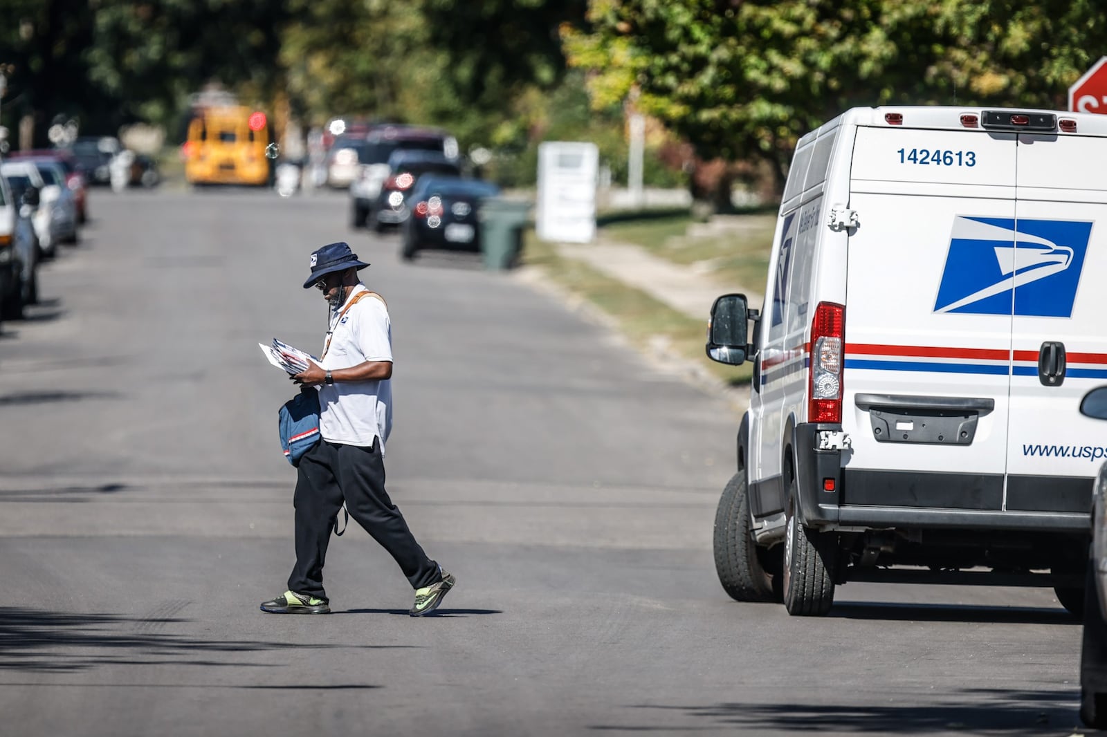 A mail carrier delivers and picks up mail on the eastside of Dayton Wednesday October 5, 2022. With the recent mail carrier robberies, postal worker are concerned for their safety. JIM NOELKER/STAFF