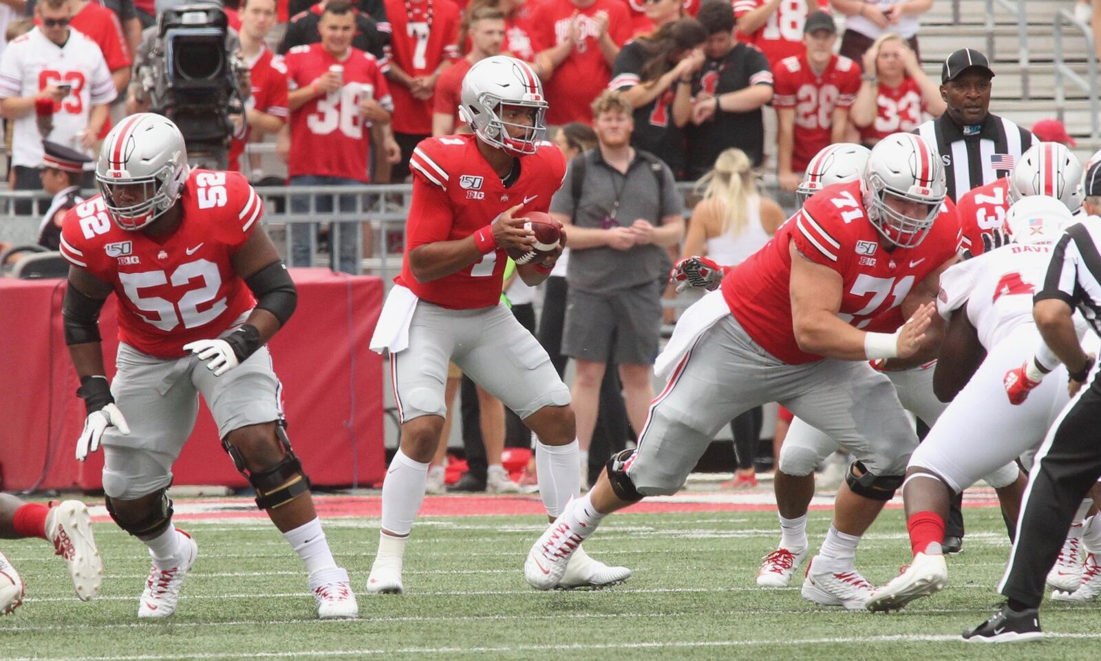 Ohio State’s Josh Myers, right, blocks after the first snap of the season to quarterback Justin Fields against Florida Atlantic on Saturday, Aug. 31, 2019, at Ohio Stadium in Columbus. David Jablonski/Staff