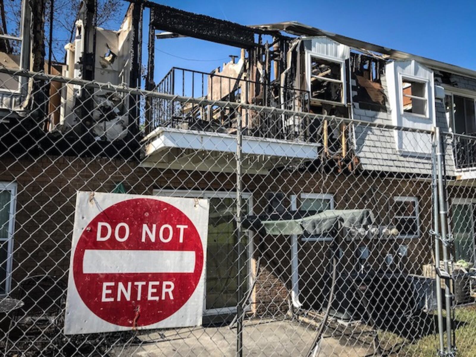 A fence surrounds a Vandalia apartment the day after a massive fire broke out Wednesday night, May 9, 2018. Fire Chief Chad Follick said May 10 that improperly discarded smoking material sparked the fire.