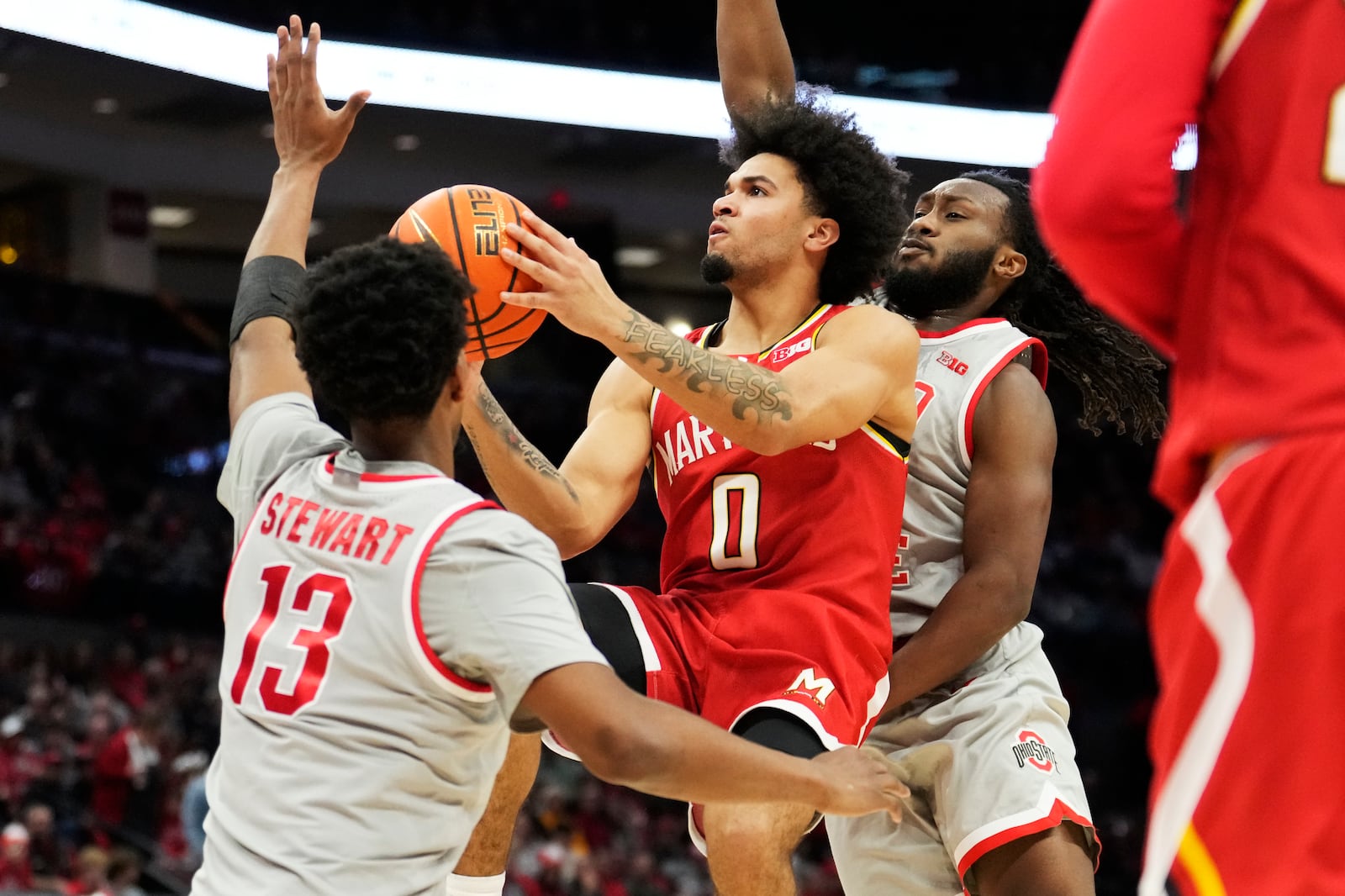 Maryland guard Ja'Kobi Gillespie (0) goes to the basket between Ohio State forward Sean Stewart (13) and guard Bruce Thornton, right, in the first half of an NCAA college basketball game Thursday, Feb. 6, 2025, in Columbus, Ohio. (AP Photo/Sue Ogrocki)