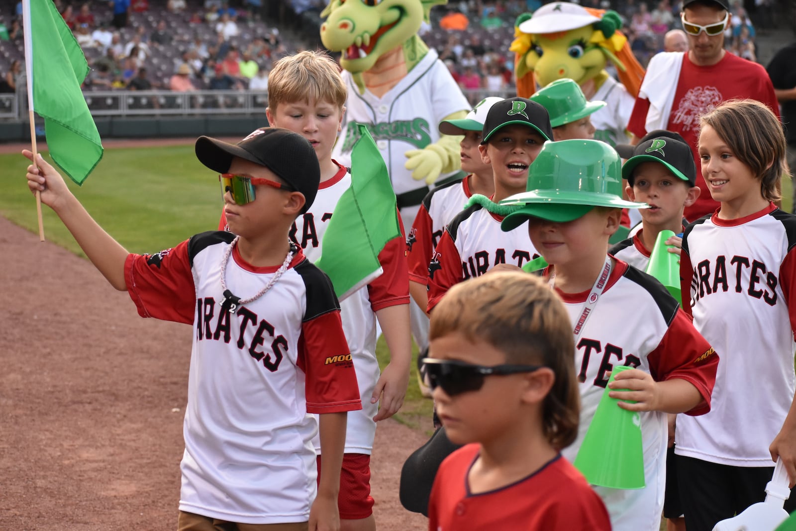 Members of the West Carrollton Baseball Club who helped cheer on Beckett Richards, 8, who ran the bases at a recent Dayton Dragons game to celebrate surviving leukemia. SAMANTHA WILDOW\STAFF