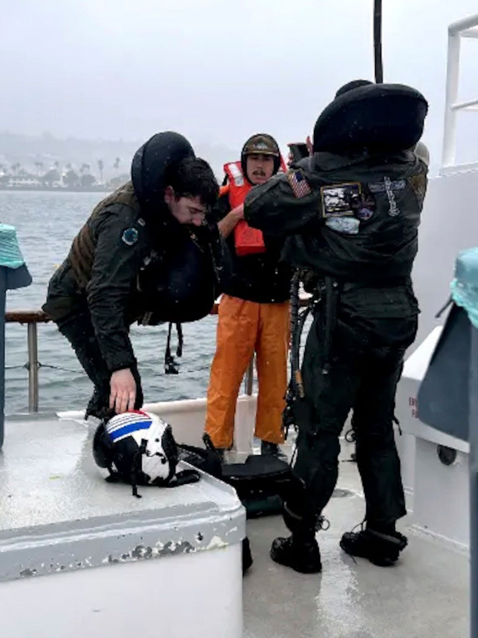 This image provided by Premier Sportsfishing shows two pilots being rescued after their E/A-18G Growler crashed off the San Diego coast Wednesday, Feb. 12, 2025. (Capt. Brandon Viets/Premier Sportsfishing via AP)