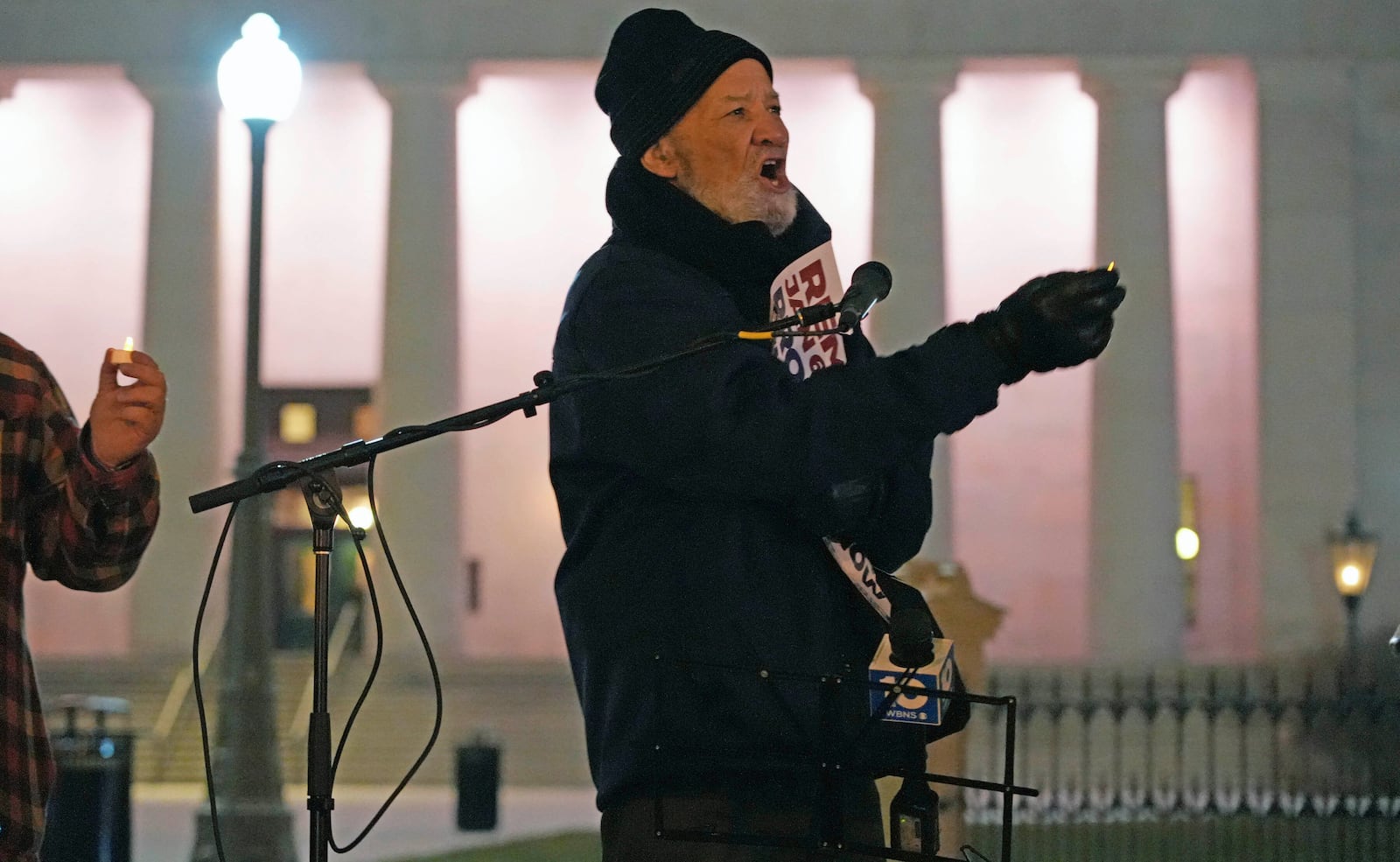 In front of the Ohio Statehouse, Tom Roberts, President of the Ohio Conference of the NAACP, makes a point at a vigil marking the one-year anniversary of the U.S. Capitol insurrection., Thursday, Jan. 6, 2022. About 50 people attended the Columbus event, which included several speakers and was one of more than 220 planned in cities across the country. Roberts lives in Dayton. (Doral Chenoweth/The Columbus Dispatch via AP)