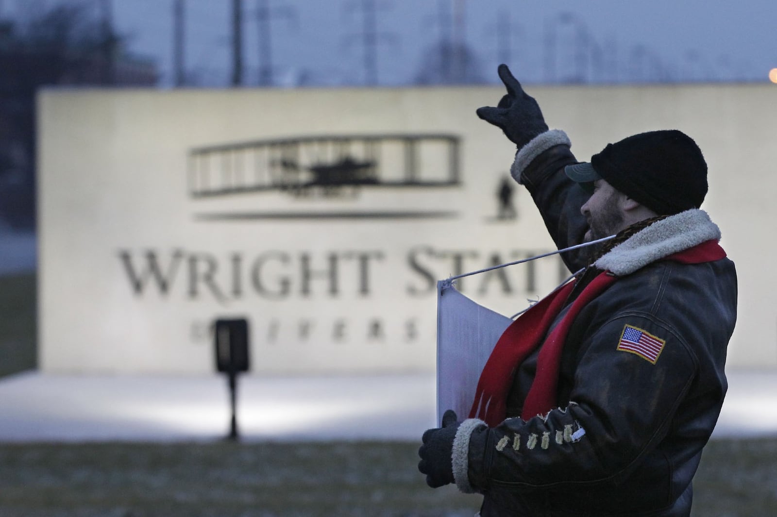 David Castellano, production manager and associate professor of Theater Design and Technology, acknoledges a honking car in front of Wright State. Striking members of Wright State University’s faculty union continued to picket on Thursday, the third day of the strike. Most classes continued to operate with some consolidated, some taught by substitutes, and others taught online. TY GREENLEES / STAFF