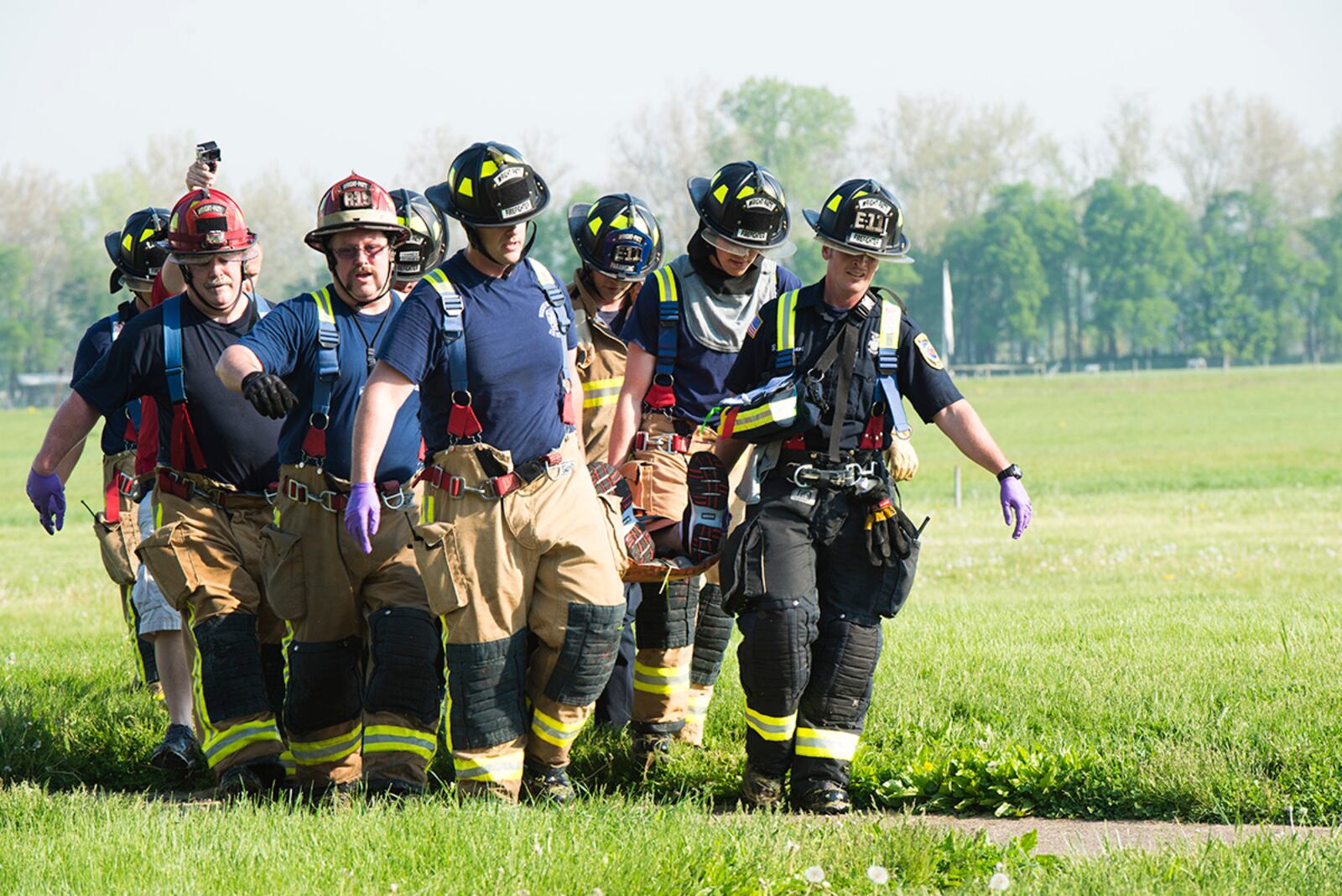 Members of the 788th Civil Engineer Squadron Fire Department work alongside local firefighters during a May 2015 mass-casualty exercise at Wright-Patterson Air Force Base. The event gave the departments a chance to train and learn together, ensuring they are always ready. U.S. AIR FORCE PHOTO/WESLEY FARNSWORTH