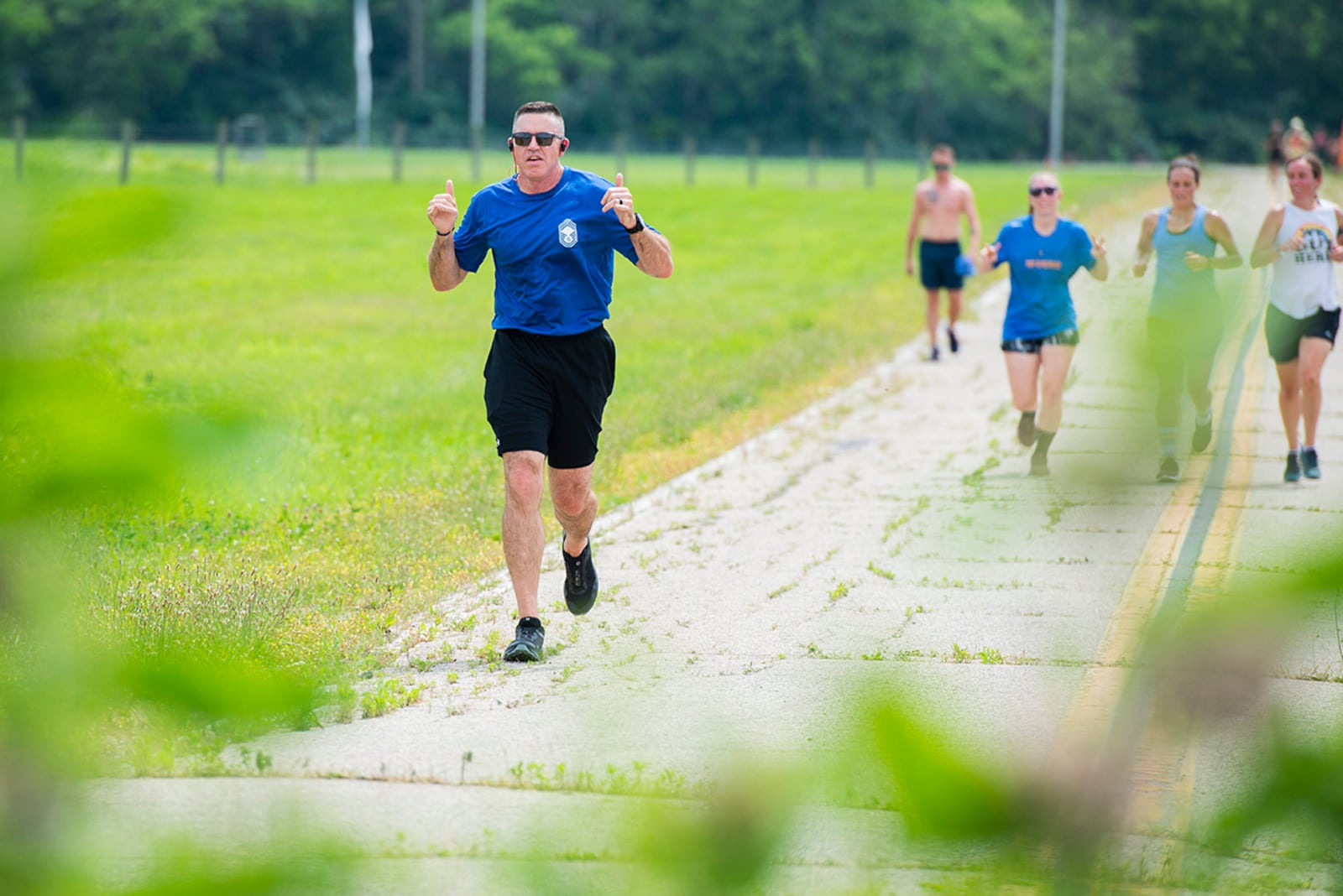 Chief Master Sgt. Jason Shaffer, 88th Air Base Wing command chief, takes part in the Pride Month 5K run through Huffman Prairie at Wright-Patterson Air Force Base on June 24. Pride Month celebrates members of the LGBTQ community. Huffman Prairie is a national landmark where the Wright brothers conducted tests to refine the techniques of powered flight. U.S. AIR FORCE PHOTO/WESLEY FARNSWORTH